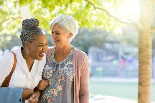 istock Diverse female friends walking in park 1049053788
