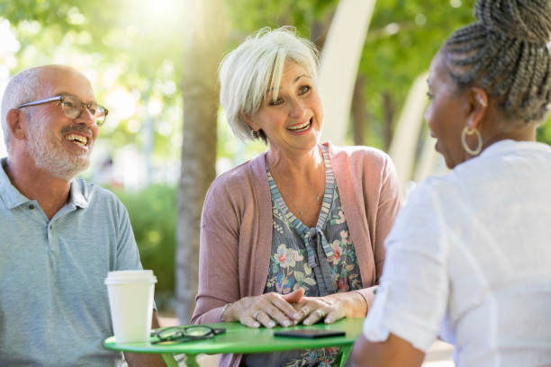 istock Senior couple talk with friend over coffee 1049053792