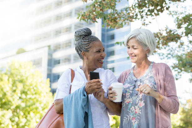istock Active senior women walk in park together 1049053822
