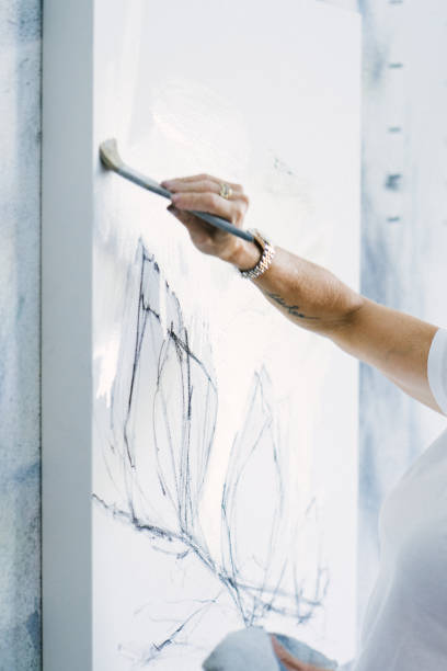 istock Woman painting canvas in art studio 1049054208