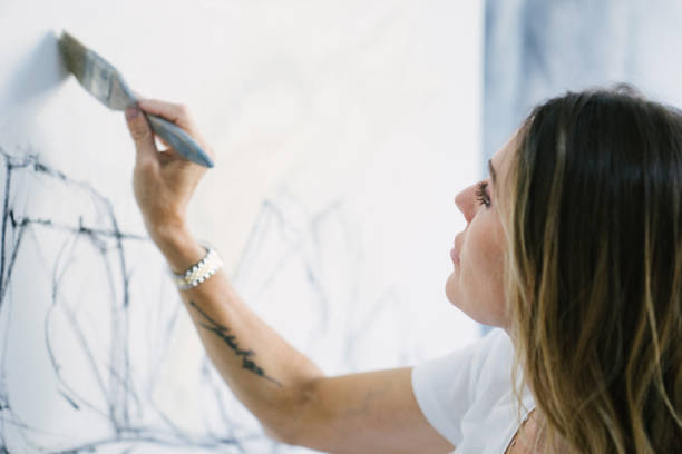 istock Woman painting canvas in art studio 1049054322