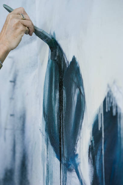 istock Woman painting canvas in art studio 1049056826