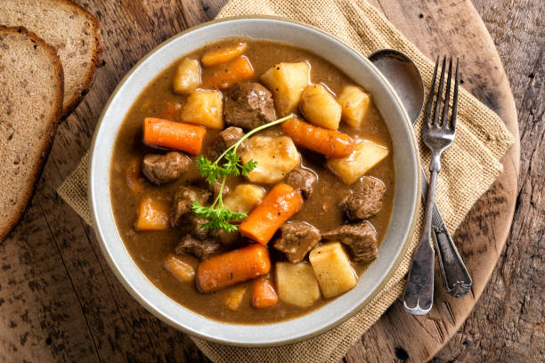Hearty Beef Stew A bowl of delicious homemade beef stew with carrots, potato, onion and turnip. beef stew stock pictures, royalty-free photos & images