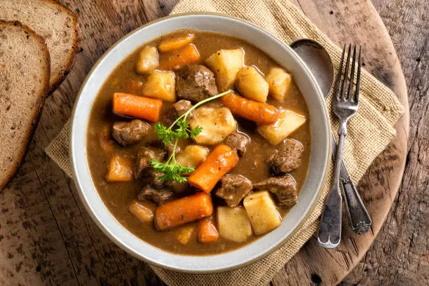 A bowl of delicious homemade beef stew with carrots, potato, onion and turnip.