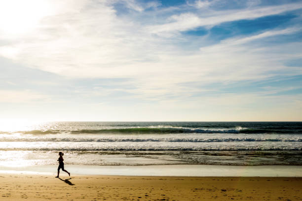istock Woman exercising on the beach 1049060434