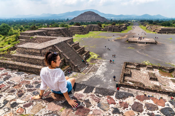 Tourism in Mexico - young adult tourist at ancient pyramids Tourism in Mexico City - young adult visits ancient Teotihuacan pyramids maya temple stock pictures, royalty-free photos & images