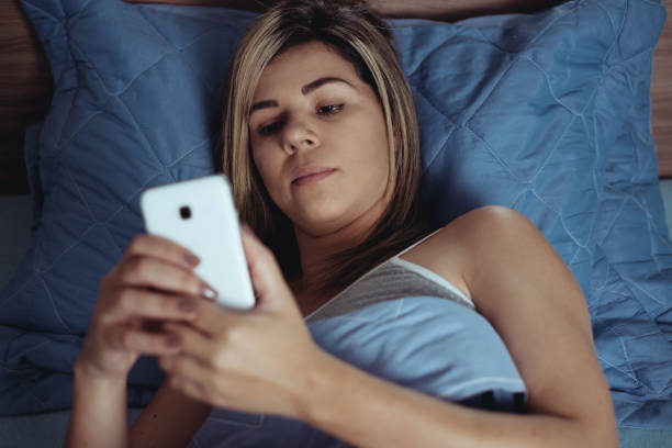 istock Women are using the smart phone on the bed before she sleeping at night. Mobile addict concept. 1049063436