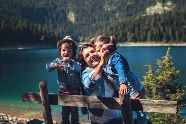 istock Family in a forest taking selfie group portrait 1049066122