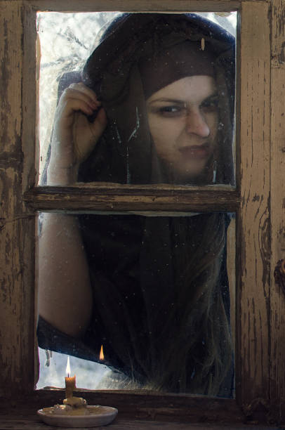 istock evil witch outside the window, Halloween, she came for you. 1049069108