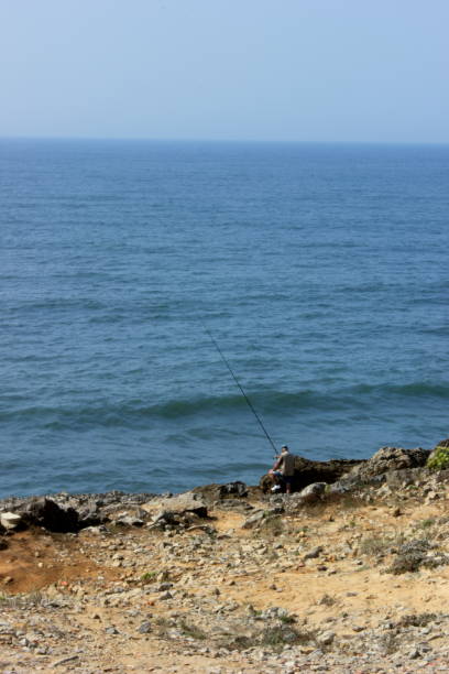 istock Fishing on the cliff 1049071628