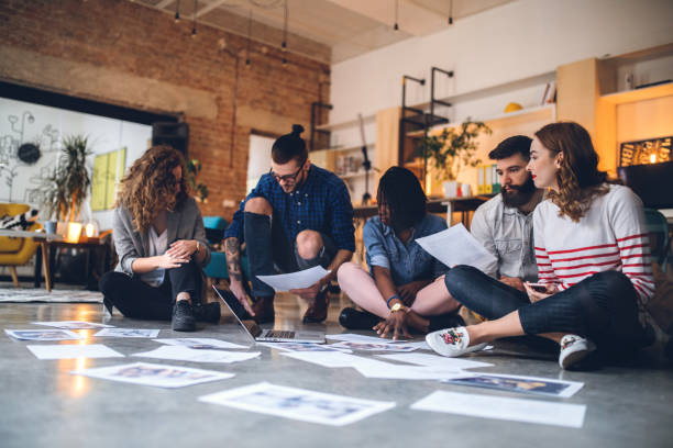 istock Teamwork Of Designers In Messy Working Environment 1049084474
