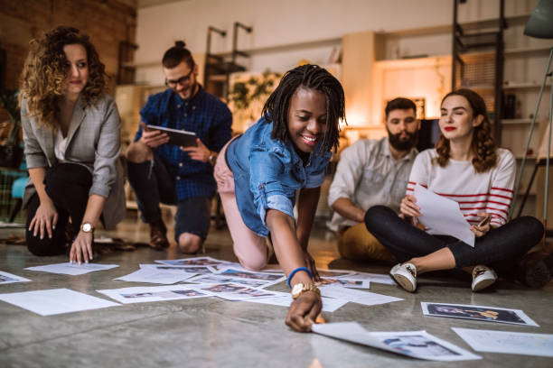 istock Young Creative People Picking Right Photographs 1049084492