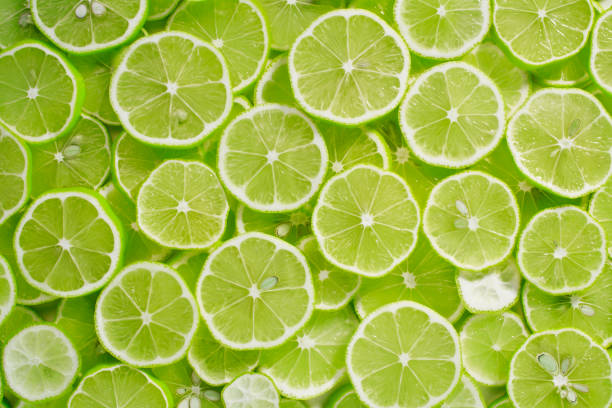 Lime Background Lime Background lemon fruit stock pictures, royalty-free photos & images