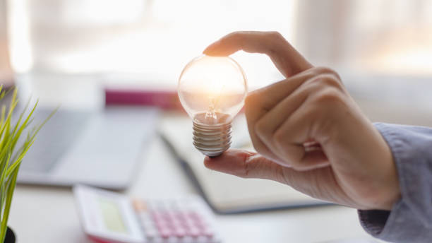 istock Concept Creativity and innovative or idea. Businesswoman hand holding light bulb with light bulbs of new idea and innovation. 1049089496