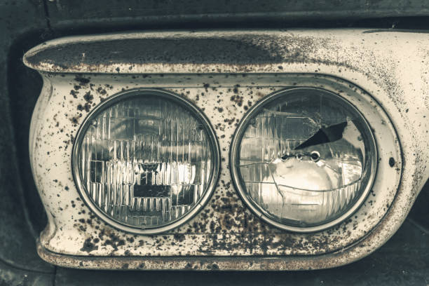 Close-up of headlights on a vintage pick-up truck.  One is broken.