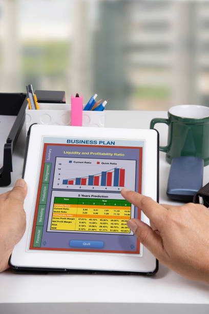 istock Someone working on business plan by using digital tablet on desk in office. 1049094484