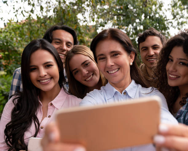 istock Happy teacher with a group of students taking a selfie 1049099172