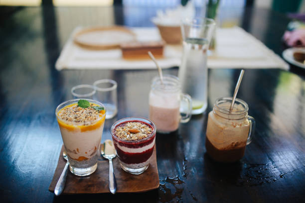 Close up image of a healthy organic breakfast, in a cafe on the Koh Phangan island in Thailand. Fruit smoothie and oatmeal, mixed with yogurt with added chia seeds.