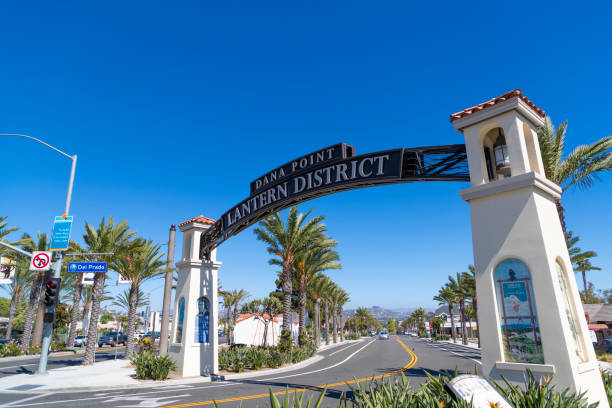 Dana Point - Lantern District The Dana Point/Lantern District sign arching across the road in Dana Point, California. dana point stock pictures, royalty-free photos & images