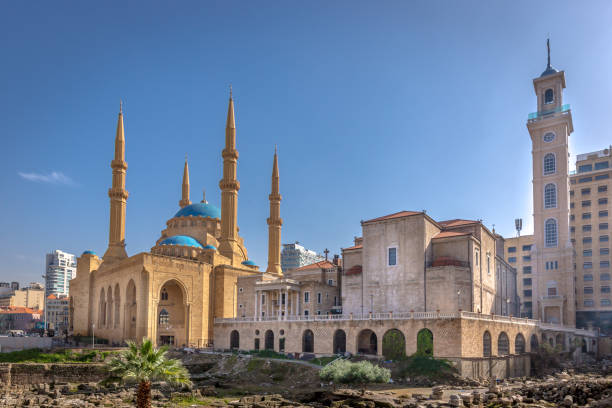 A mosque and a church together in Beirut, capital of Lebanon in a blue sky day A mosque and a church together in Beirut, capital of Lebanon in a blue sky day lebanon beirut stock pictures, royalty-free photos & images