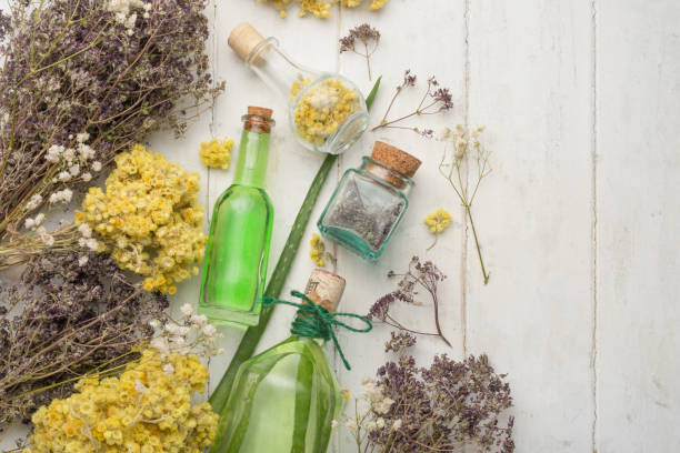 istock Medicinal herbs in glass jars on a light background, with an empty space for writing 1049112808