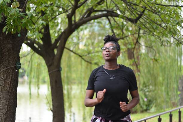 istock Young woman running at the park 1049115368
