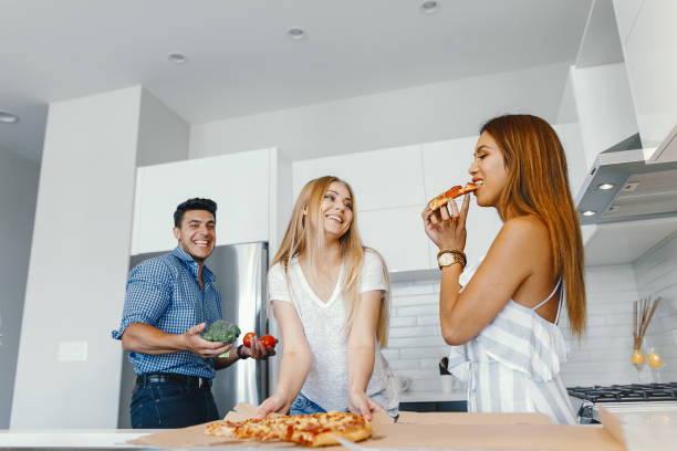 istock friends eatting in a kitchen 1049118116