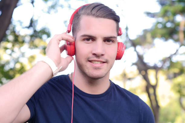 istock Young man with headphones in a park. 1049120930