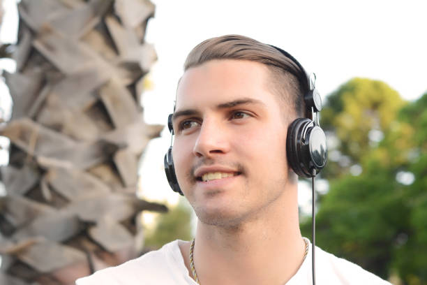 istock Young man with headphones in a park. 1049120944
