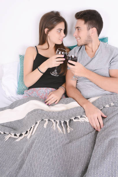 istock Couple drinking wine in bed. 1049132306