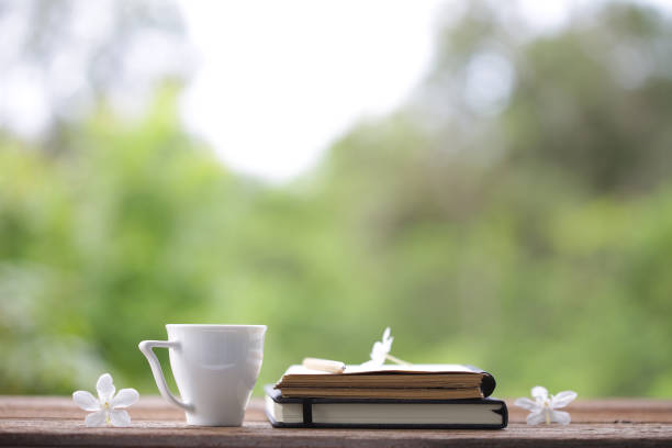 istock White cup with frangipani flower and notebooks 1049140278