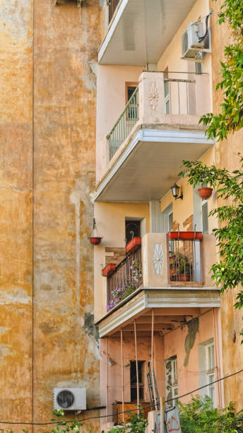 istock Side view on a decayed facade of the old house with balconies. 1049145492