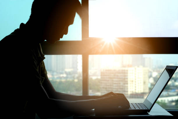 istock Silhouette of man work computer at desk in office. Health concept 1049145668