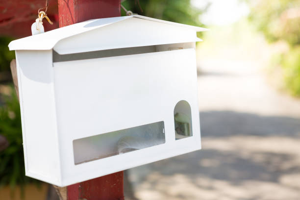 istock White mailbox With sunlight on village background 1049151972