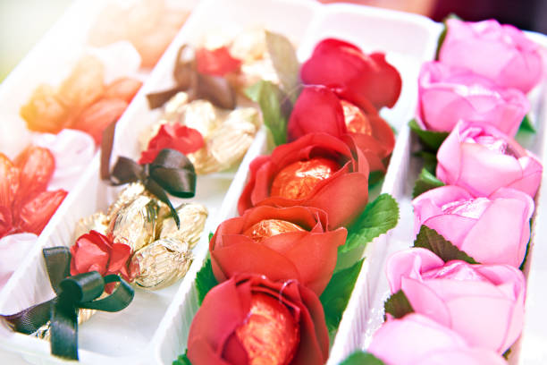 chocolate candies in wrapping paper with flower-shaped