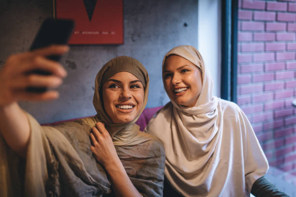 istock Arabic students taking a selfie for social media at a cafe 1049162976