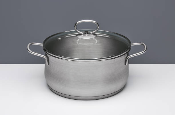 istock New kitchen pot for cooking soup with lid, isolated. 1049174164