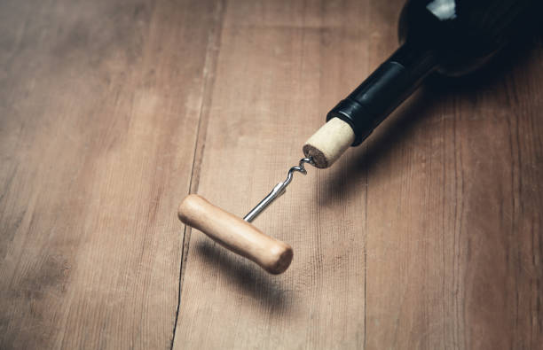 istock Corkscrew and bottle of wine on wood background. 1049174850
