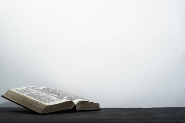 istock Bible on the old table. Beautiful background 1049177576