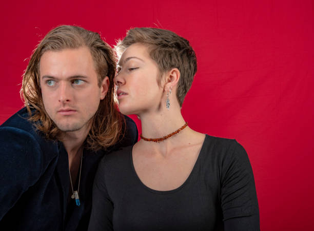 istock Young affectionate couple.She whispers in his ear. 1049189836