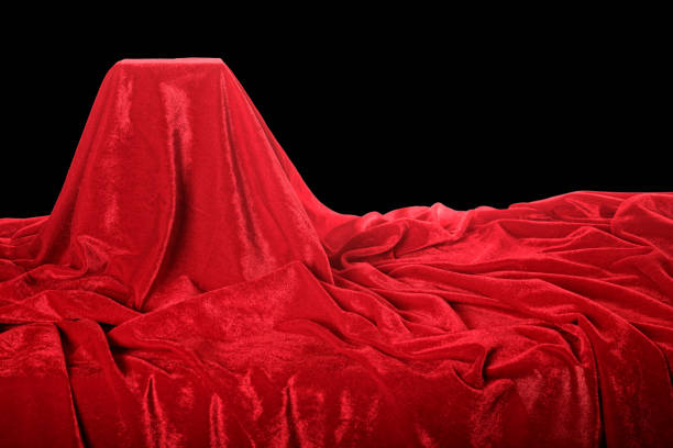 Close up empty red velvet pedestal over black background