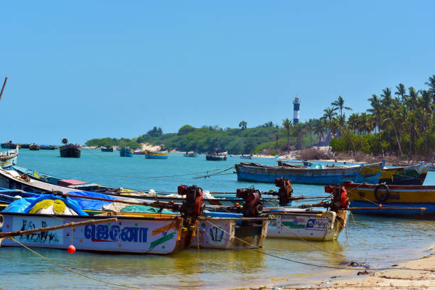istock Boats on the beach and lighthouse view 1049192130