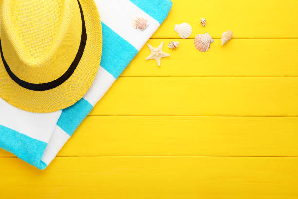 istock Summer accessories with seashells on yellow wooden table 1049192472