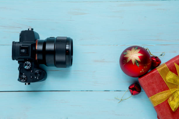 istock Digital camera with Christmas ball on the table 1049192506