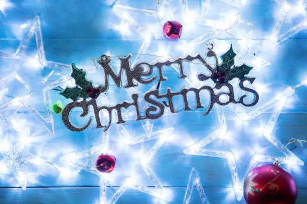 High angle view of Merry Christmas text with Christmas star lights on the table
