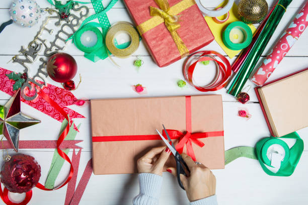 istock Woman hands preparing Christmas gift boxes 1049192672