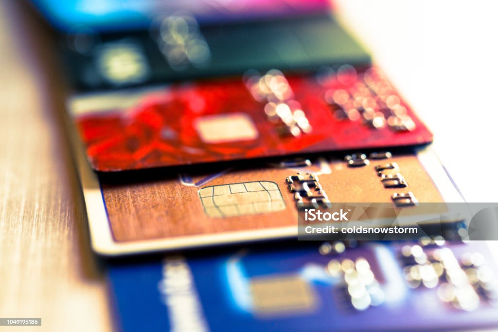 Abstract macro credit card background Close up macro color image depicting an abstract view of a collection of debit and credit cards and numeric digits. Room for copy space. Credit Card Stock Photo