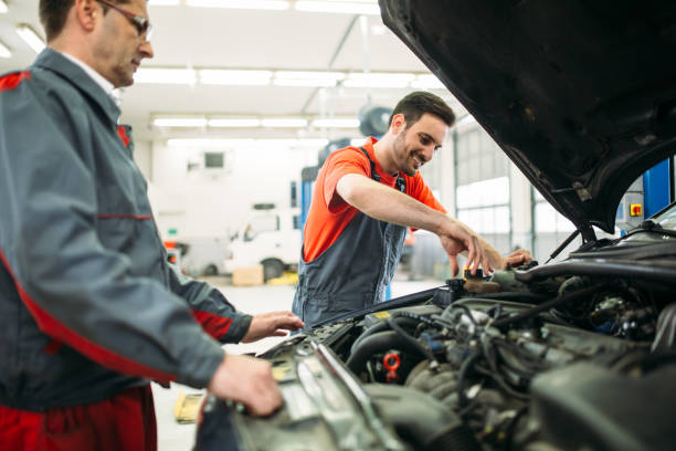 istock Car mechanics working at automotive service center 1049198290