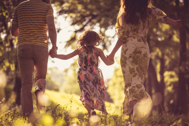 istock Rear view. Family running in the springtime. 1049198462