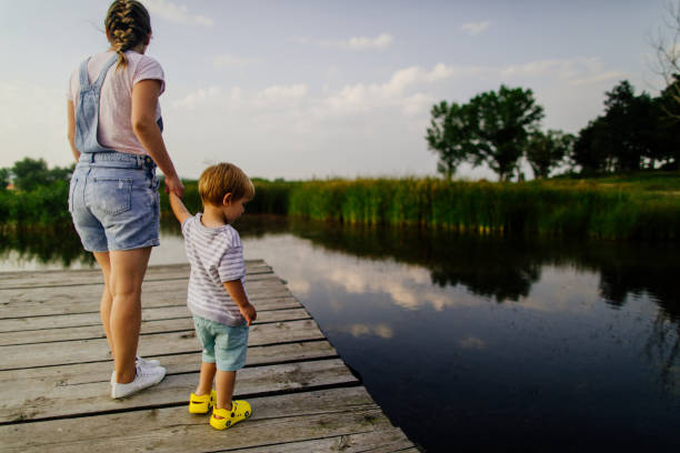 istock Mother and son on lake dock 1049198662